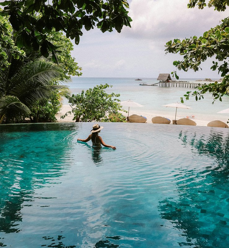 Couple relaxing on pristine Maldives beach during India Maldives Romantic Escape