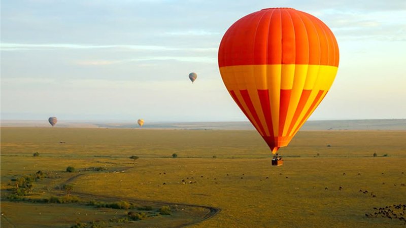 Hot air balloon safari over Maasai Mara during Great Wildebeest Migration Kenya 2025